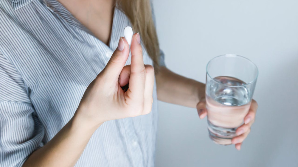 woman taking an antibiotic